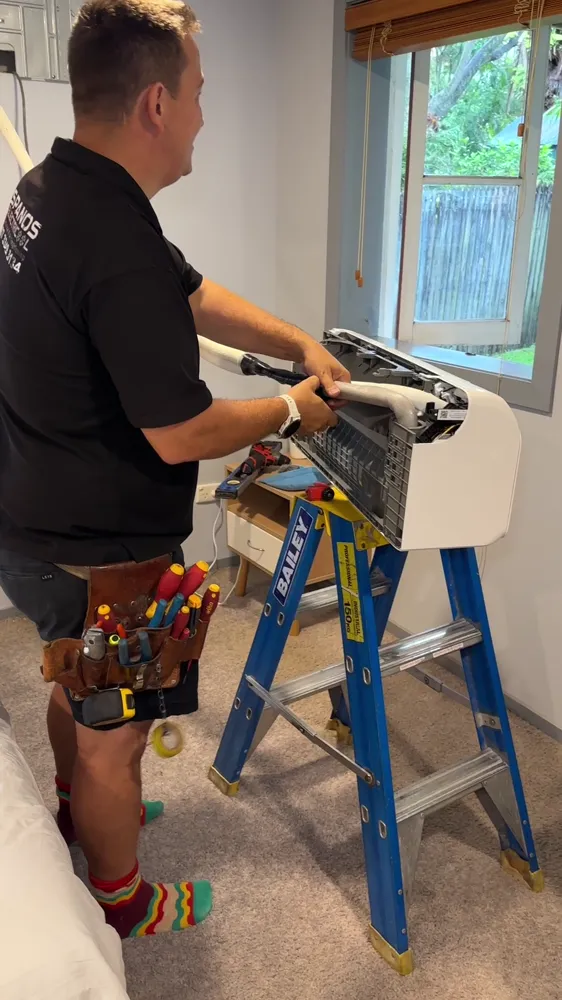 Spanos ElectriCool technician preparing a split system indoor unit
