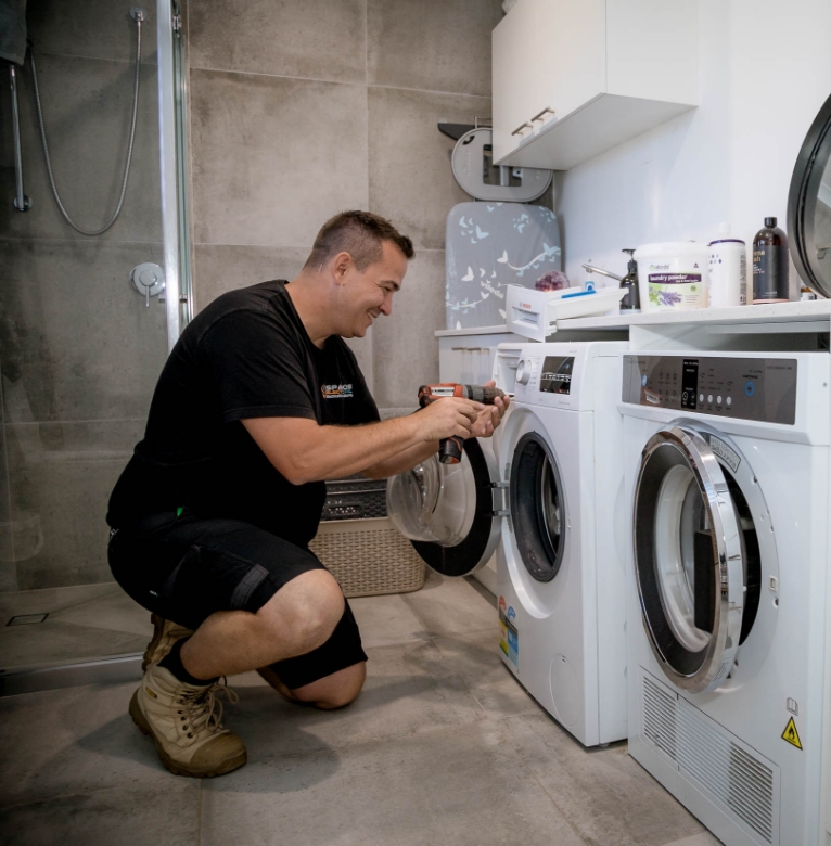 Spanos ElectriCool technician completing Heating Installation Brisbane, setting winter temperature on a wall controller in a Brisbane bedroom.